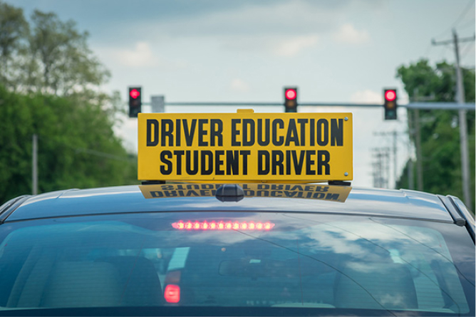 a student driver sign over a car