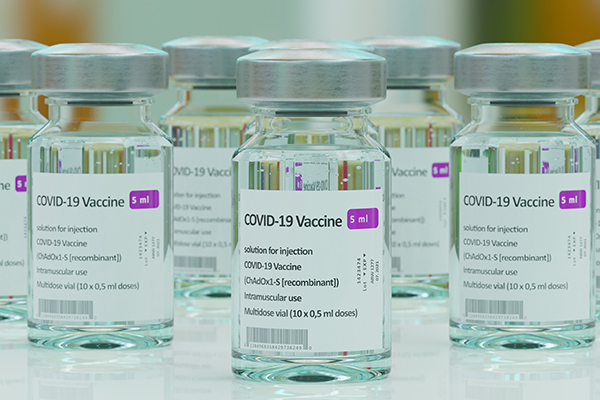 Clear bottle of COVID-19 Vaccine bottles, head on shot 