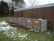 photograph of a series of outdoor composting bins in use at Mansfield Middle School