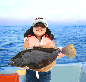 Girl holding summer flounder (fluke) before releasing fish back in the water