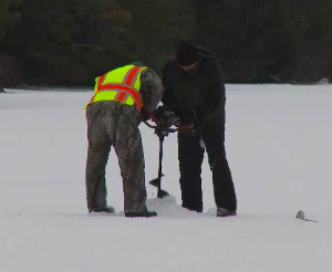 Drilling hole in ice with power auger