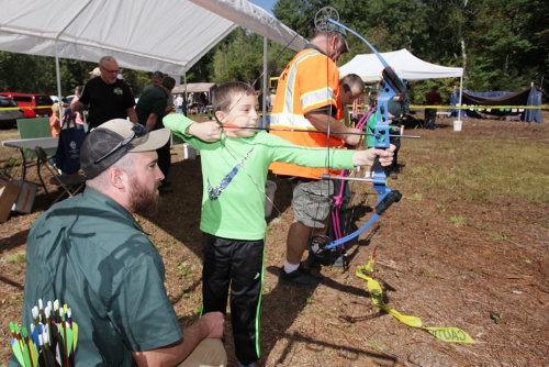 Child trying archery at DEEP's Hunting and Fishing Day