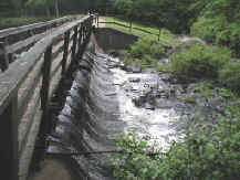 Photograph of man made waterfall at end of pond