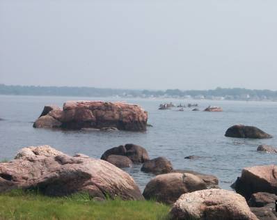Photograph of rocks of the north moraine which extend out into Clinton Harbor.