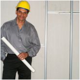 Image of contractor in front of new gypsum wallboard