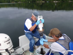 Monitoring staff work to process a sediment core collected from a lake.