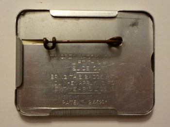 1941 through 1956 metal license holder with attached metal pin and slide out door