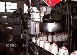 Photograph of a machine that fills milk containers.