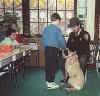Picture of a State Animal Control Officer with a dog in a elementary school classroom.