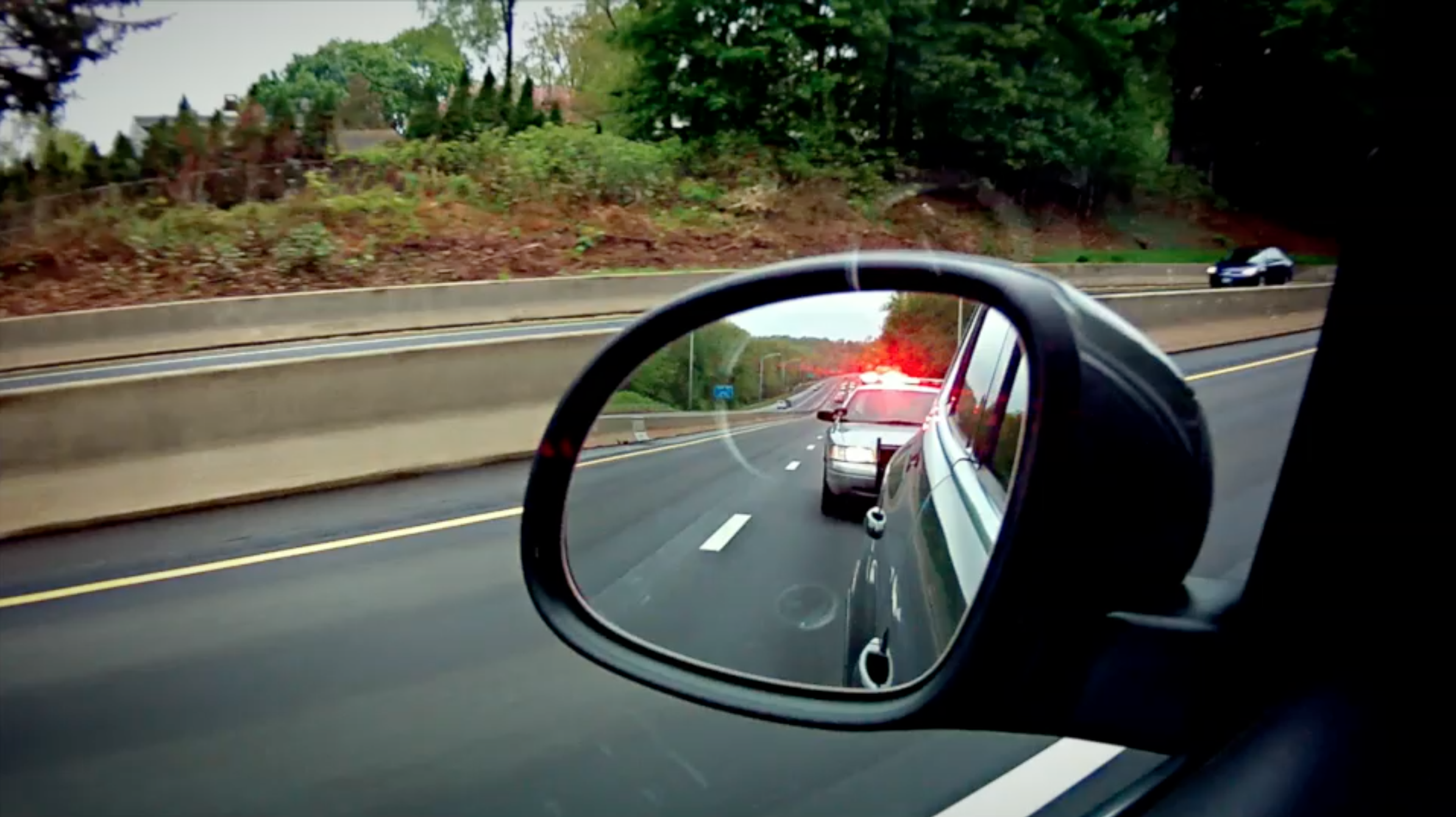 Image_Side Mirror View of Police Car Behind