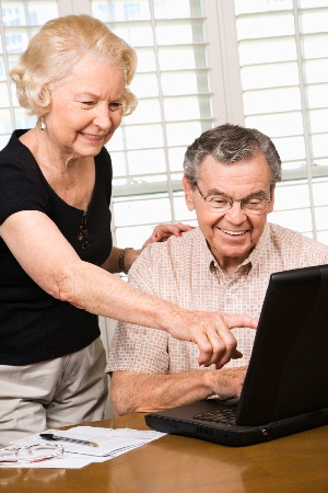 Elderly couple looking at computer