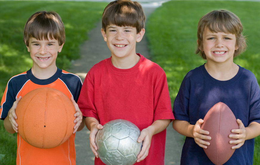 Boys holding balls