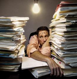 man surrounded by paper