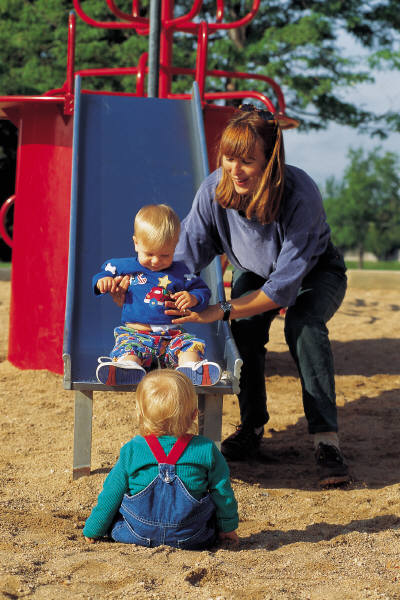 mom and kids on slide