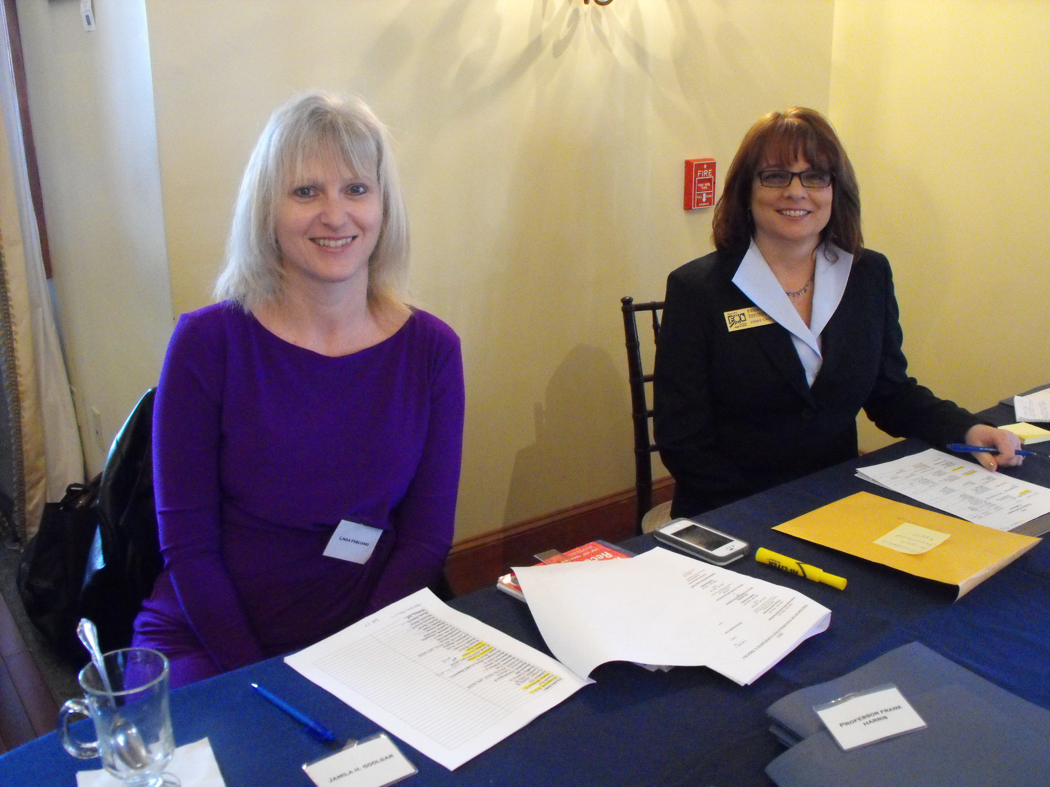 FOI Staff members Linda Fasciano (left) and Cindy Cannata (right) welcome conference attendees to the Riverhouse.