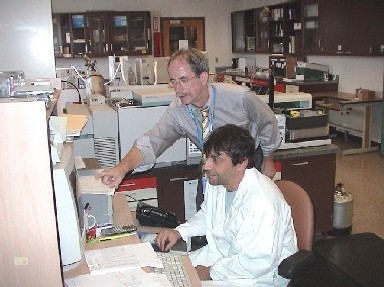 Photo of Jack Bennett, Environmental Chemistry Section Chief at the State Public Health Laboratory, reviewing drinking water test data with an analyst.