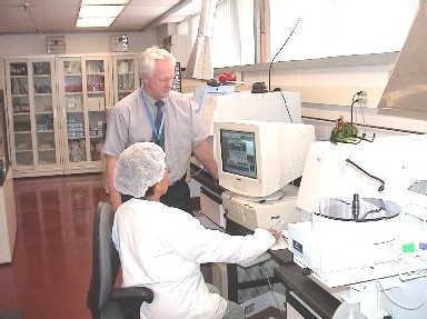 Photo of Bob Howard, Quality Assurance Section Chief at the State Public Health Laboratory, reviewing quality control data for childhood blood lead testing.