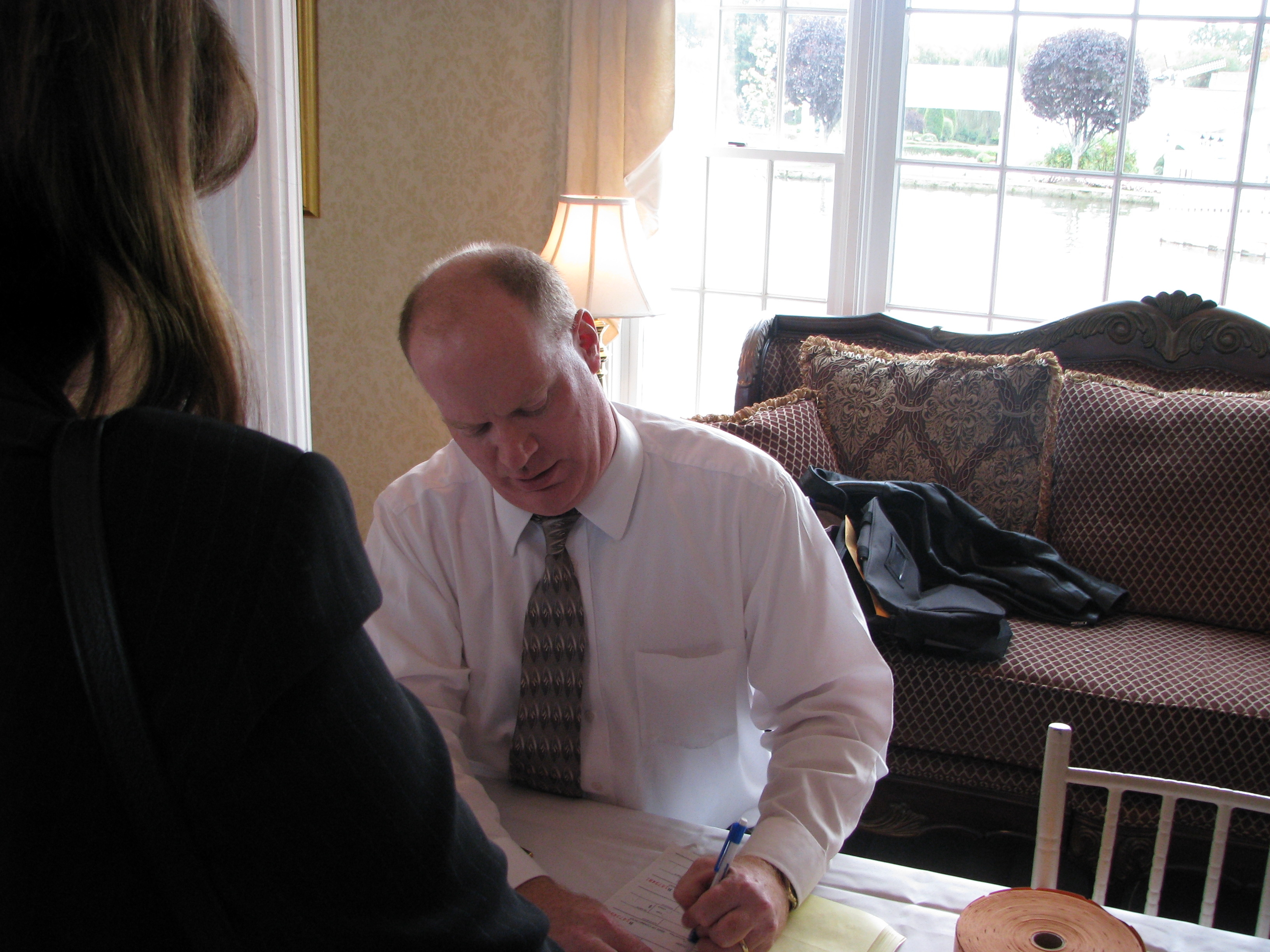 MAC Treasurer Dave Lynn signs in Manager's Day attendees.