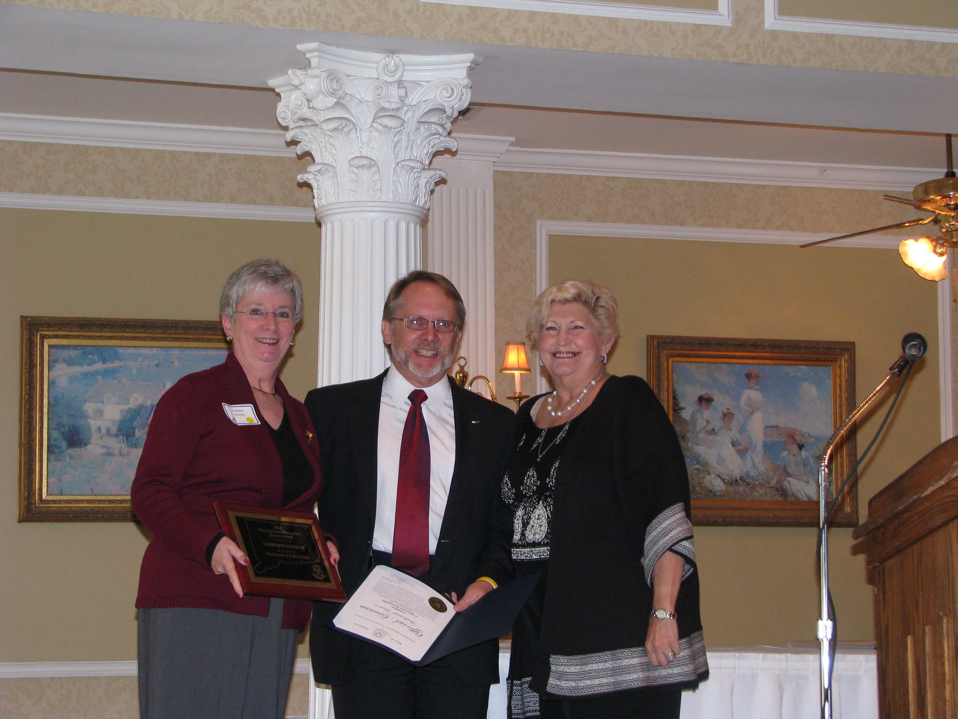 Dr. Martin Anderson, Deputy Commissioner of DAS, presents Ms. Kennelly with her award.