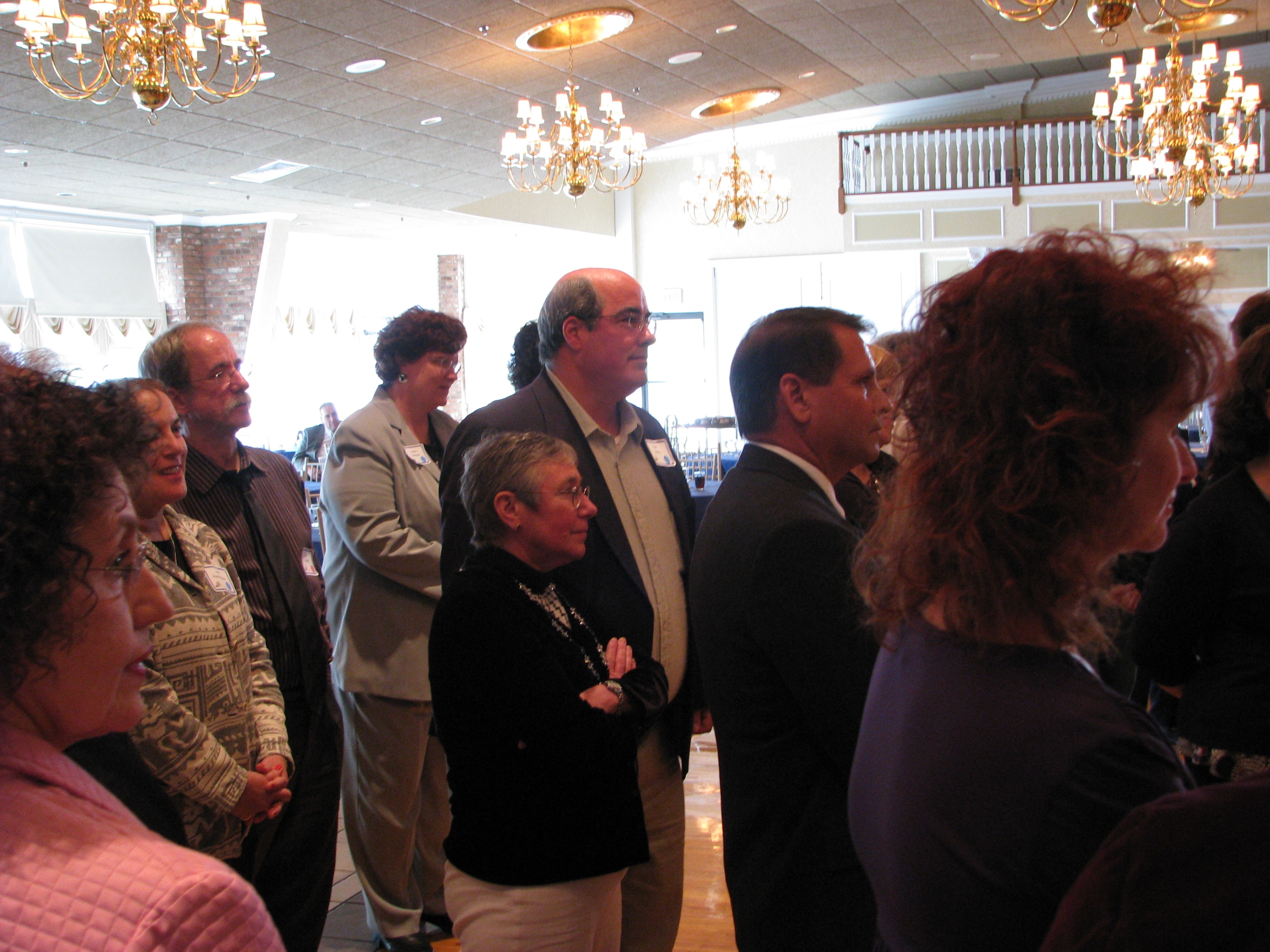 A group of managers listens intently to group activity instructions.
