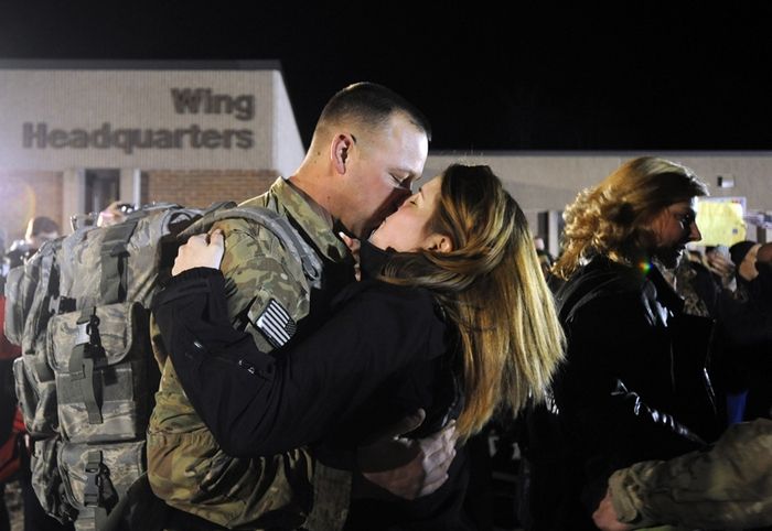Staff Sgt. Jim Diederick is welcomed back by his wife