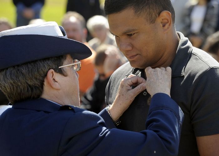 Dr. Schwartz presents Donaven Jack with Wartime Service Medal