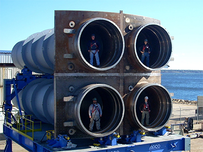 Workers stand pose for a photo in the four-tube “quad-pack” built for the U.S. Ohio Replacement-class and U.K. Successor-class.