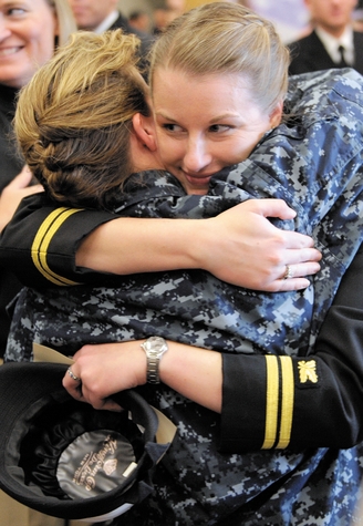 U.S. Navy Lt. Krysten Pelstring, right, gets a hug from Lt. Cmdr. Emori Moore, division medical officer for the Submarine Schoo