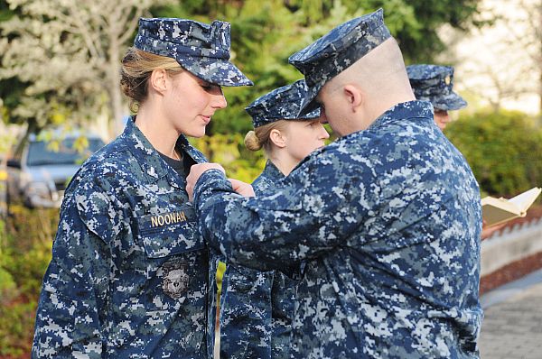 Lt. Jennifer Noonan receives her submarine warfare office device.