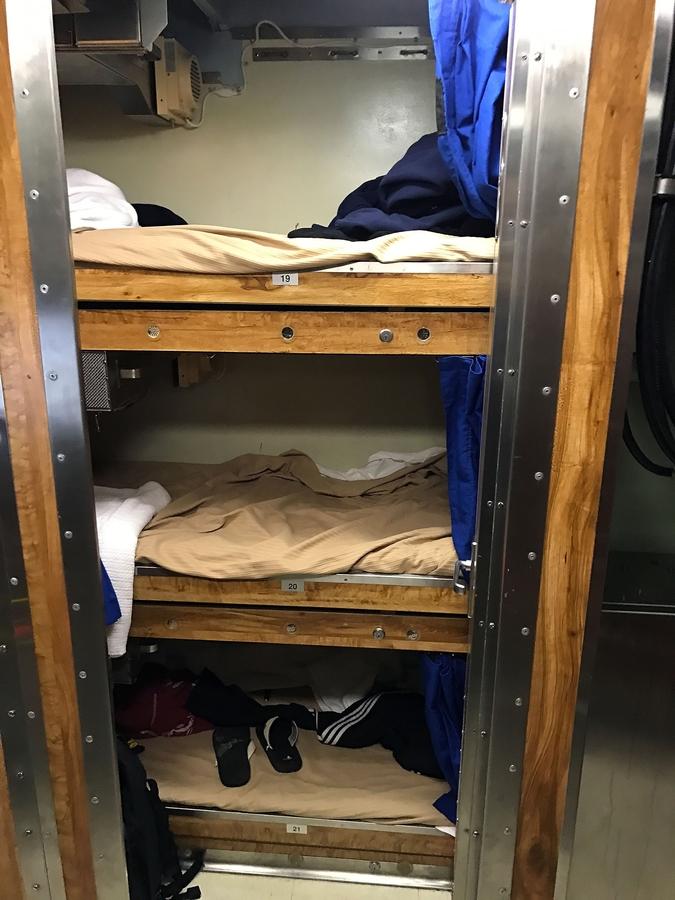 Three racks where sailors sleep aboard the USS John Warner.