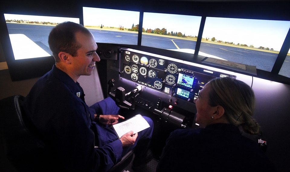 USCG Academy Aviation Club President Roesch works with 2nd Class Cadet  Books on flight instruction