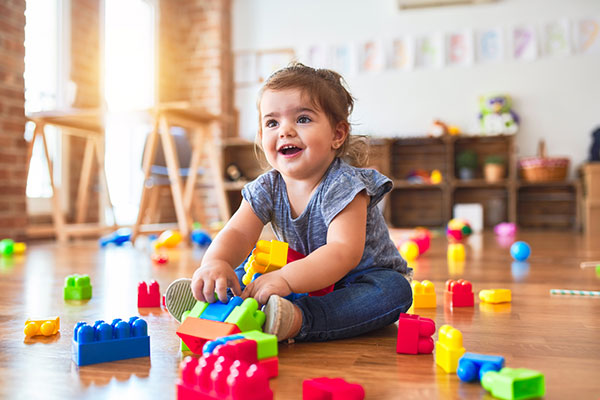 baby on floor with toys