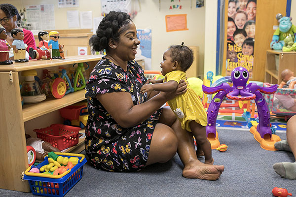 preschool teacher with infant