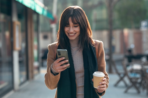woman on street with phone