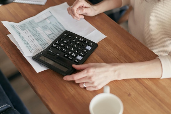 person sitting at a desk paying bills