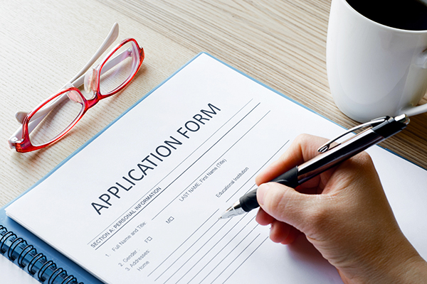 Person filling out application.