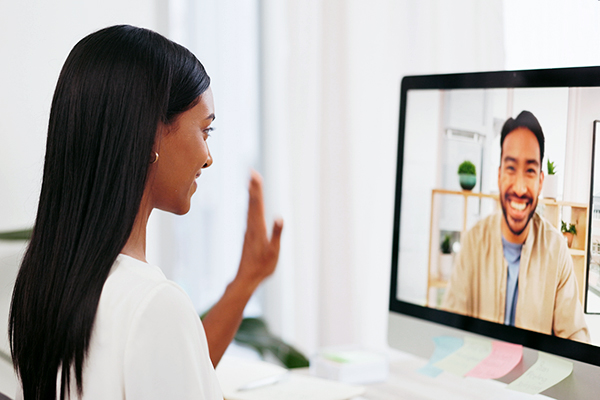 Woman holding virtual interview at computer.