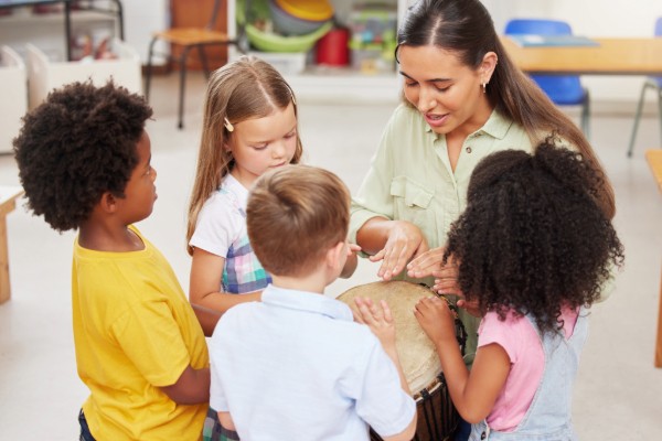 Teacher sitting on the floor with preK students