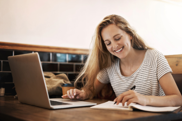 Woman smiling and sitting at computer
