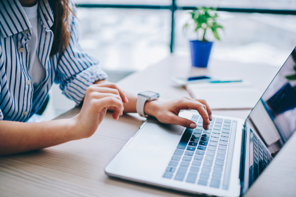 Woman typing at computer