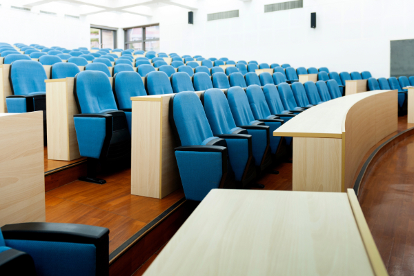Empty college lecture hall with rows of seats
