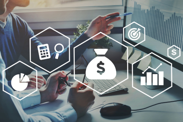 person on computer surrounded by finance images