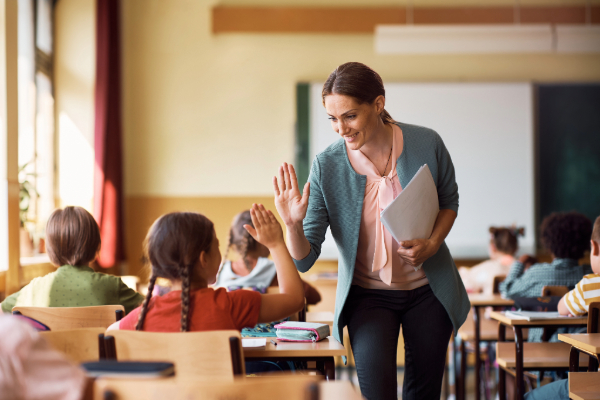 Teacher giving a student a high five