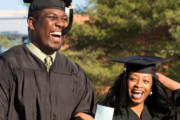 man and woman in graduation robes