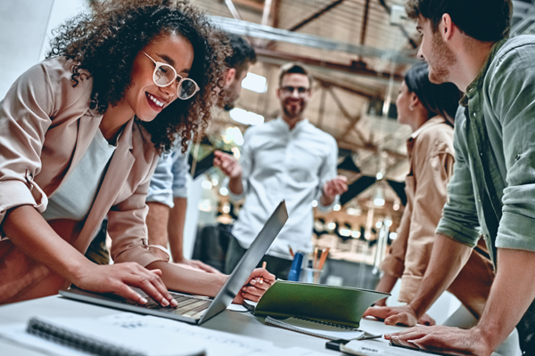 Group of people discuss technology in team meeting