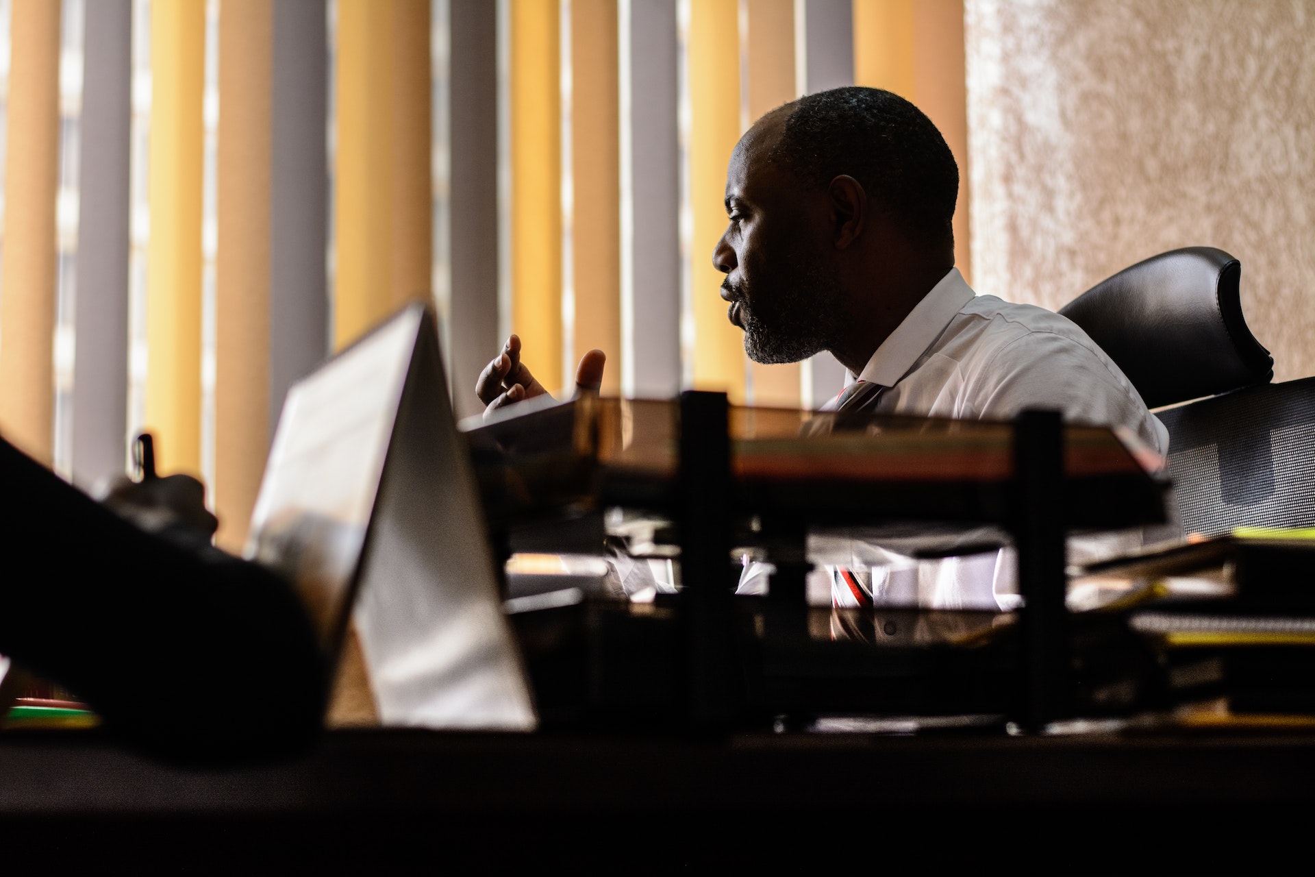 Black principal working at his desk