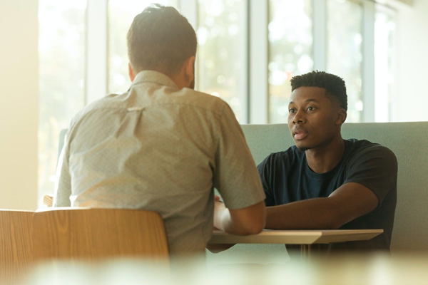 Men at table talking